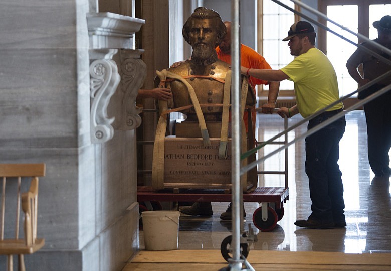 Workers load the Nathan Bedford Forrest bust onto an elevator as it is removed from the State Capitol Friday, July 23, 2021, in Nashville, Tenn. The State Building Commission on Thursday gave approval for the relocation of the Forrest bust to the Tennessee State Museum, a final step in a process that has taken more than a year since Gov. Bill Lee first said it was time for the statue to be moved. (George Walker IV /The Tennessean via AP)