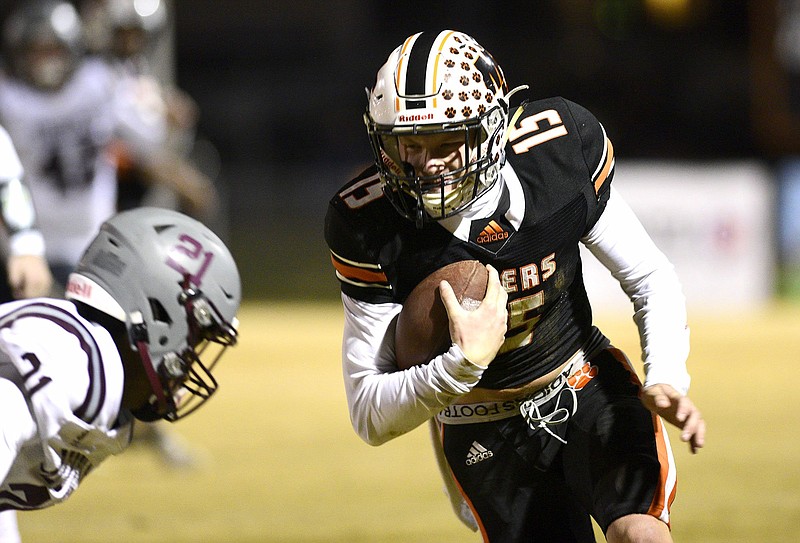 Staff Photo by Robin Rudd /  Meigs County's Cameron Huckabey (15) picks up yardage after a pass reception.  The Meigs County Tigers host the South Greene Rebels in the quarterfinals of the TSSAA football playoff on November 20, 2020.  