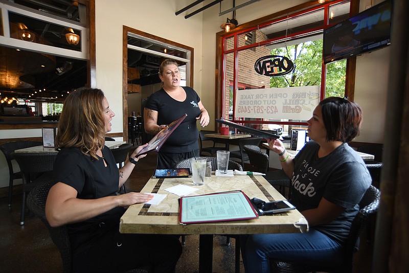 Staff Photo by Matt Hamilton / Waitress Jennifer Condra, middle, takes the order of Stacy Lynn, left, and Kali Wood at The Big Chill & Grill on Thursday, July 22, 2021. 