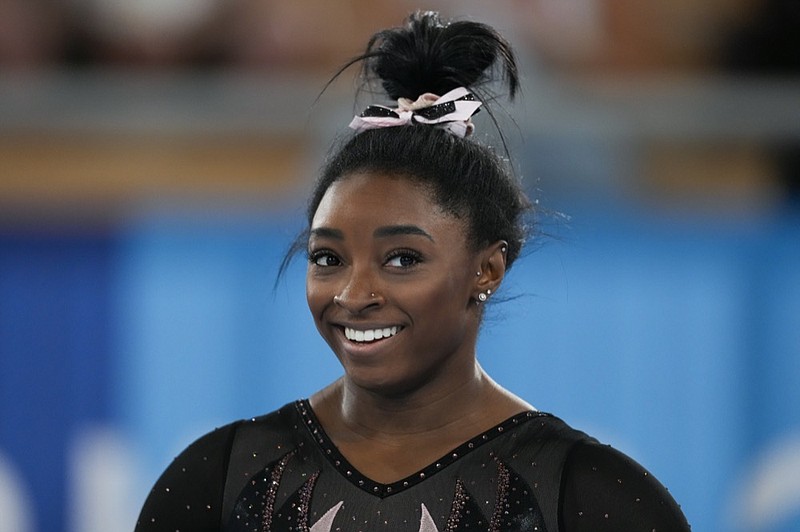 Simone Biles of the United States smiles as she trains for artistic gymnastics at Ariake Gymnastics Centre ahead of the 2020 Summer Olympics, Thursday, July 22, 2021, in Tokyo, Japan. (AP Photo/Ashley Landis)


