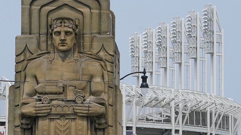 A guardian rests on the Hope Memorial Bridge within site of Progressive Field, Friday, July 23, 2021, in Cleveland. Cleveland's new name was inspired by two large landmark stone edifices near the downtown ballpark, referred to as traffic guardians, on the Hope Memorial Bridge over the Cuyahoga River. The team's colors will remain the same, and the new Guardians' new logos will incorporate some of the architectural features of the bridge. (AP Photo/Tony Dejak
