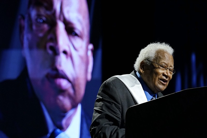 Rev. James Lawson speaks speaks during a celebration of life marking the one-year anniversary of U.S Rep. John Lewis's death Saturday, July 17, 2021, in Nashville, Tenn. A portrait of Rep. Lewis is shown in the background. (AP Photo/Mark Humphrey)