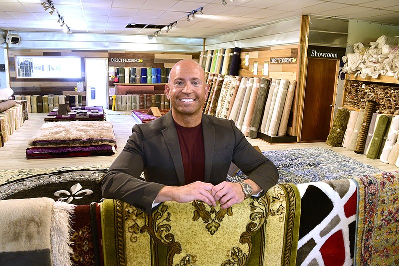 Staff Photo by Robin Rudd / Staff Photo by Robin Rudd / Jordan Parker in the Direct Flooring showroom. Parker is third-generation in the flooring industry. At the age of 10, he began working for his grandfather, Barney Solomon, for $1 an hour. He recently opened Direct Flooring to the public, his own business off Rossville Boulevard, and supports the Boulevard Project by giving a percentage of weekend rug sales to efforts to improve the area.