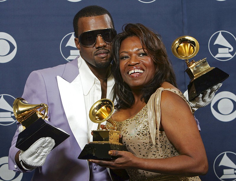 In this Feb. 8, 2006, file photo, Kanye West and his mother, Donda, hold his three awards backstage at the 48th Annual Grammy Awards in Los Angeles. West won for best rap album, solo and song. Kanye West unveiled his 10th studio album, "Donda," in front of a packed crowd in Atlanta. His album was named after his mother, who died at the age of 58 following plastic surgery complications in 2007. (AP Photo/Reed Saxon, File)