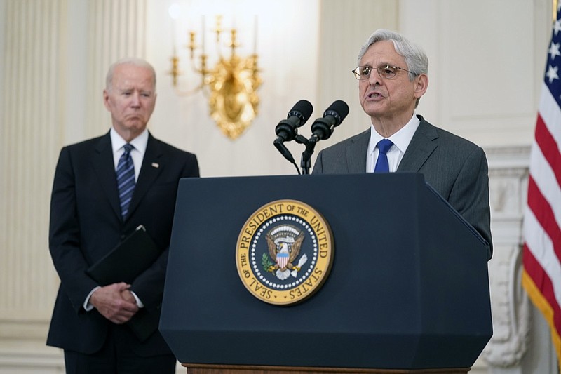FILE - In this June 23, 2021 file photo, President Joe Biden listens as Attorney General Merrick Garland speaks during an event in the State Dining room of the White House in Washington to discuss gun crime prevention strategy. Garland traveled to Chicago last week to announce an initiative to crack down on violent crime and gun trafficking. The Justice Department's 93 U.S. attorneys are likely to be central to that effort.(AP Photo/Susan Walsh)