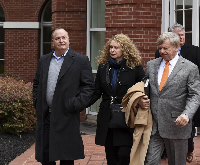 FILE - In this Feb. 9, 2016, file photo, former Pilot Flying J president Mark Hazelwood, left, leaves federal court after being arraigned in Knoxville, Tenn. Federal prosecutors are not pursuing a new trial against the former president of Pilot Flying J and two of his former employees after their 2018 convictions in a cheating scheme were overturned. A motion made in U.S. District Court in Knoxville asks a judge to sign off on a request to drop the remaining charges against Hazelwood, former Vice President Scott "Scooter" Wombold and former account representative Heather Jones. (Michael Patrick /Knoxville News Sentinel via AP, File)