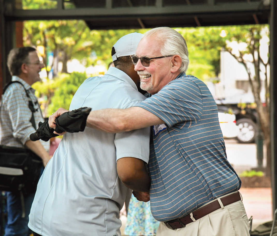 Photography by Mark Gilliland / Kevin Love greets Mike Bradshaw