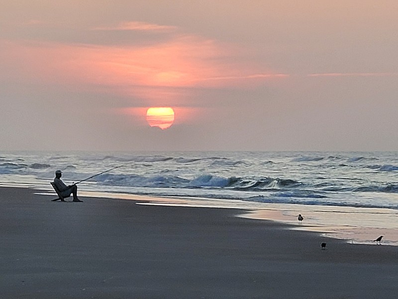 Photo contributed by Larry Case / A fisherman holds his line in the surf on Topsail Island in North Carolina. When hillbillies make their annual summer trek to the beach, they simply must do a little fishing in the salt water, writes outdoors columnist Larry Case.