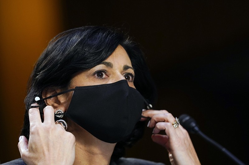 Dr. Rochelle Walensky, director of the Centers for Disease Control and Prevention, adjusts her face mask during a Senate Health, Education, Labor and Pensions Committee hearing on the federal coronavirus response on Capitol Hill in Washington, in this Thursday, March 18, 2021, file photo. Walensky says new mask-wearing guidance, coupled with higher rates of vaccination against COVID-19, could halt the current escalation of infections in "a couple of weeks." The director of the Centers for Disease Control and Prevention told "CBS This Morning" she hopes more stringent mask-wearing guidelines and other measures won't be necessary as the country heads into the fall. (AP Photo/Susan Walsh, Pool, File)