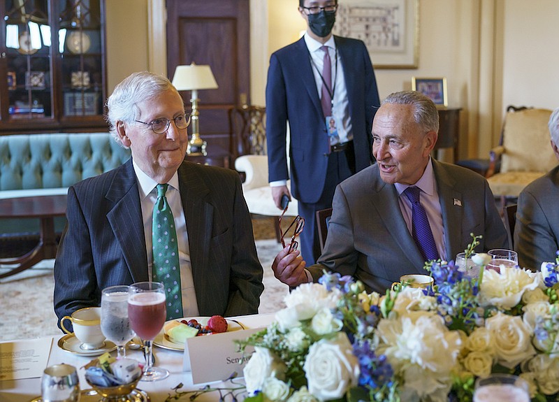Senate Minority Leader Mitch McConnell, R-Ky., left, and Senate Majority Leader Chuck Schumer, D-N.Y., right, are seated together during a luncheon with Iraqi Prime Minister Mustafa Al-Kadhimi, at the Capitol in Washington, Wednesday, July 28, 2021. Senate Republicans have reached a deal with Democrats over major outstanding issues in a $1 trillion infrastructure bill and say they are ready to vote to take up the bill. (AP Photo/J. Scott Applewhite)