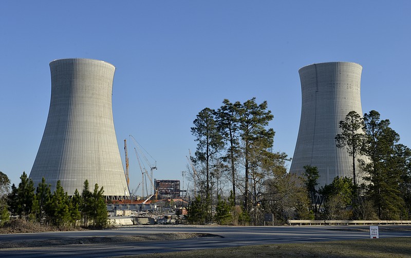 FILE - In this March 22, 2019 file photo, the cooling towers of the still under construction Plant Vogtle nuclear energy facility are seen in Waynesboro, Ga. Two new reactors at Georgia's Plant Vogtle will cost another billion dollars, with shareholders of the parent company of Georgia Power Co. taking a $460 million loss and other owners absorbing the rest. The news came Thursday, July 29, 2021, as Atlanta-based Southern Co. again admitted what outside experts have been telling regulators for months — its $27 billion-plus project at the complex outside Augusta will take longer and cost more than previously estimated. (Michael Holahan/The Augusta Chronicle via AP, File)