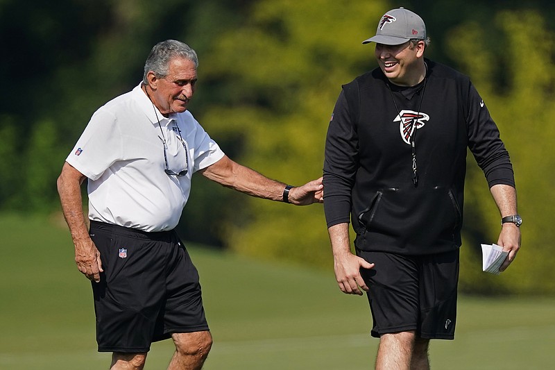 AP photo by John Bazemore / Atlanta Falcons owner Arthur Blank, left, walks with new head coach Arthur Smith at the team's first practice of training camp Thursday in Flowery Branch, Ga.