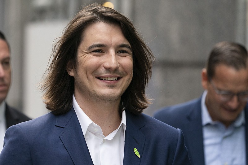 Vladimir Tenev, CEO and Co-Founder of Robinhood, walks in New York's Times Square following his company's IPO, Thursday, July 29, 2021. Robinhood is selling its own stock on Wall Street, the very place the online brokerage has rattled with its stated goal of democratizing finance. Through its app, Robinhood has introduced millions to investing and reshaped the brokerage industry, all while racking up a long list of controversies in less than eight years. (AP Photo/Mark Lennihan)