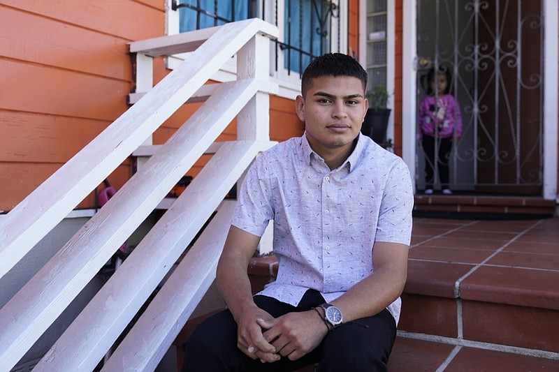 Alan Reyes Picado poses outside his home, as his niece looks on from behind, in San Francisco, California, Friday, July 9, 2021. Reyes arrived in the United States in Feb. 2021, after receiving death threats in Nicaragua and is asking for asylum. (AP Photo/Eric Risberg)

