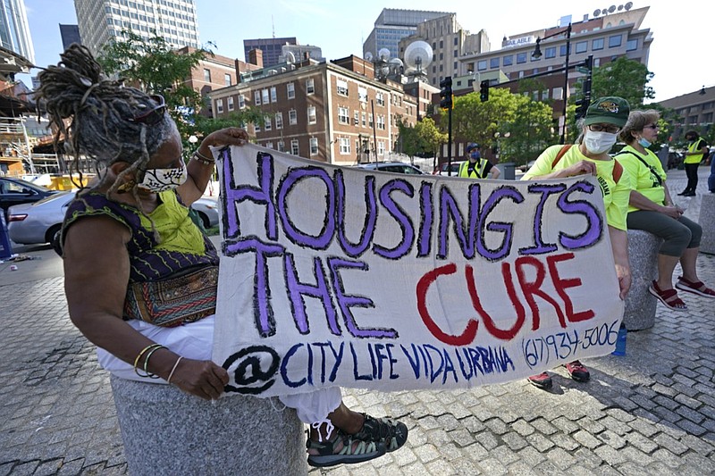 In this June 9, 2021, photo, people hold a sign during a rally in Boston protesting housing eviction. The Biden administration on Thursday, July 29, 2021, announced it will allow a nationwide ban on evictions to expire Saturday, July 31, 2021. The White House said President Joe Biden would have liked to extend the federal eviction moratorium due to spread of the highly contagious delta variant. Instead, Biden called on "Congress to extend the eviction moratorium to protect such vulnerable renters and their families without delay."(AP Photo/Elise Amendola)