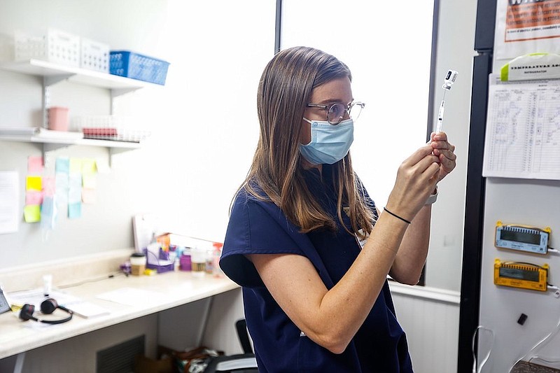 Staff photo by Troy Stolt / Nurse Practitioner Meghan Whitehead fills a syringe with the COVID-19 vaccine at LifeSpring Community Health on Wednesday, July 21, 2021 in Chattanooga, Tenn.