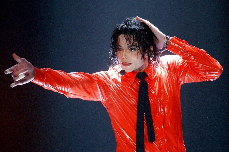 Michael Jackson performs "Dangerous" during the taping of the American Bandstand's 50th anniversary show on April 20, 2002, in Pasadena, Calif. With a series of court victories and shows beginning or returning after a long pandemic pause, Jackson's estate, and his legacy are on the upswing again. Estate co-executor John Branca said in an interview with The Associated Press that his optimism never flagged as crises hit. (AP Photo/Kevork Djansezian, File)