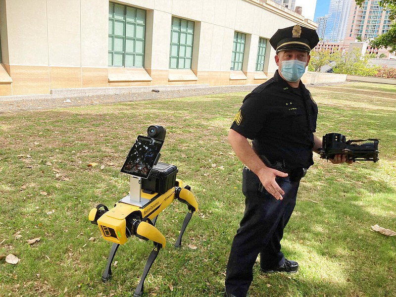 Honolulu Police Acting Lt. Joseph O'Neal demonstrates a robotic dog in Honolulu, Friday May 14, 2021. Police officials experimenting with the four-legged machines say they're just another tool, like drones or simpler wheeled robots, to keep emergency responders out of harm's way. (AP Photo/Jennifer Sinco Kelleher)