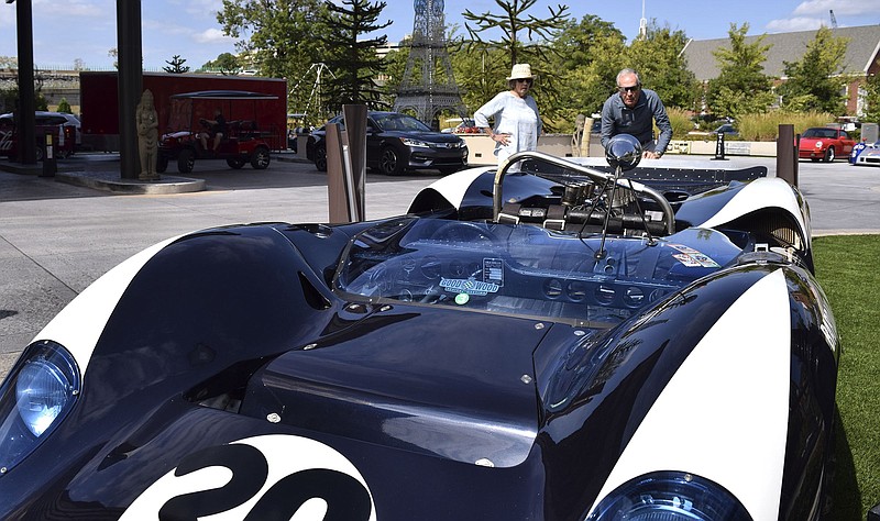 Staff File Photo by Robin Rudd/ From left, Mardy and Jack Miller, of Chattanooga, look over a Goodwood Lola race car outside the Westin during the 2019 Chattanooga Motorcar Festival.