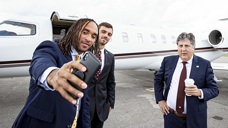 Mississippi State Athletics photo / Mississippi State outside linebacker Aaron Brule takes a picture of himself with Bulldogs receiver Austin Williams and coach Mike Leach during their recent trip to SEC Media Days in Hoover, Ala.