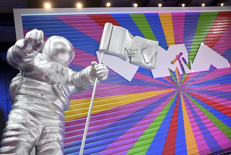 In this Aug. 20, 2018, file photo, an MTV statue appears on the red carpet at the MTV Video Music Awards at Radio City Music Hall in New York. MTV is marking its 40th anniversary with a relaunch of its iconic image of an astronaut on the moon, with an MTV flag planted nearby. On Sunday, Aug. 1, 2021 the video channel unveiled a large scale "Moon Person" during a ceremony at NASA's Kennedy Space Center in Cape Canaveral, Florida. (Photo by Evan Agostini/Invision/AP, File)