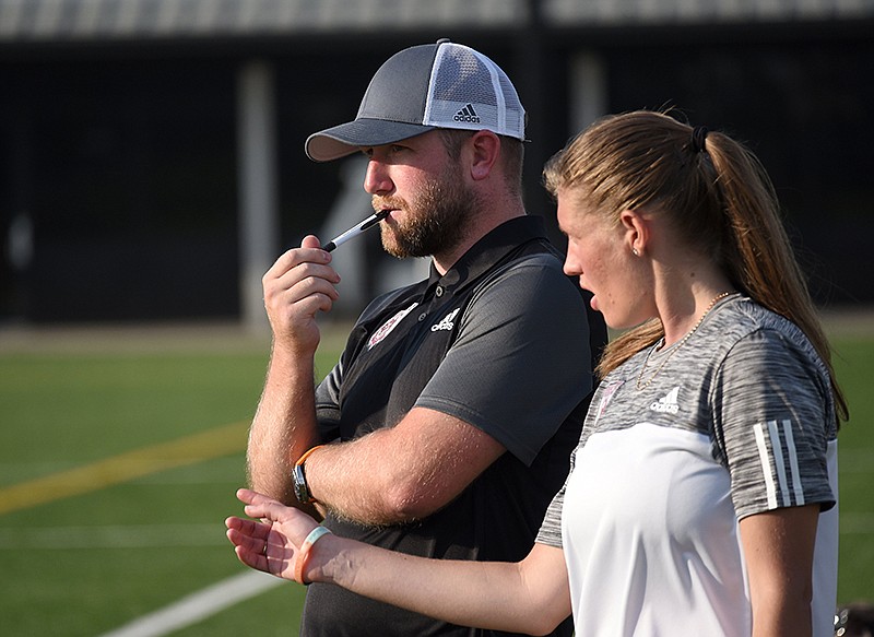 Staff Photo by Matt Hamilton / Lady Red Wolves head coach Luke Winter watches his players with assistant coach Elisha Fry during a team scrimmage at the UTC Sports Complex Friday, May 21, 2021. 