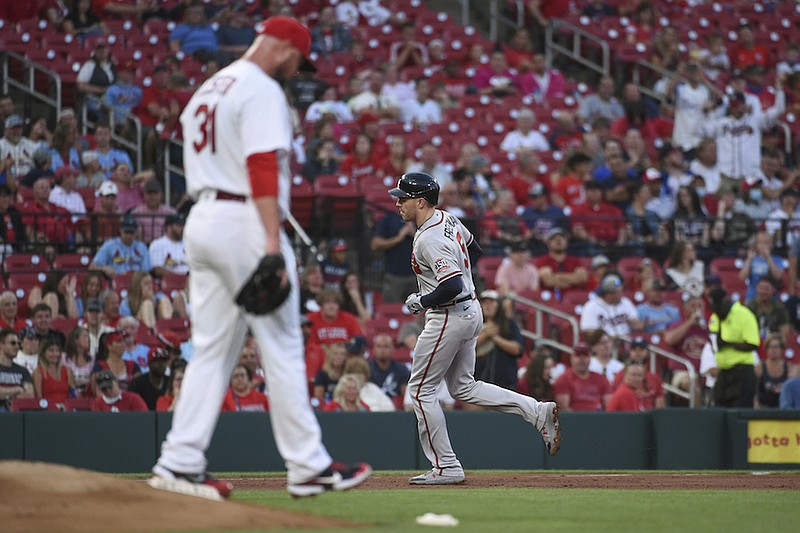 St. Louis Cardinals starting pitcher Jon Lester walks off the mound after giving up a home run to Atlanta Braves' Freddie Freeman, rear, during the second inning of a baseball game Tuesday, Aug. 3, 2021, in St. Louis. (AP Photo/Joe Puetz)