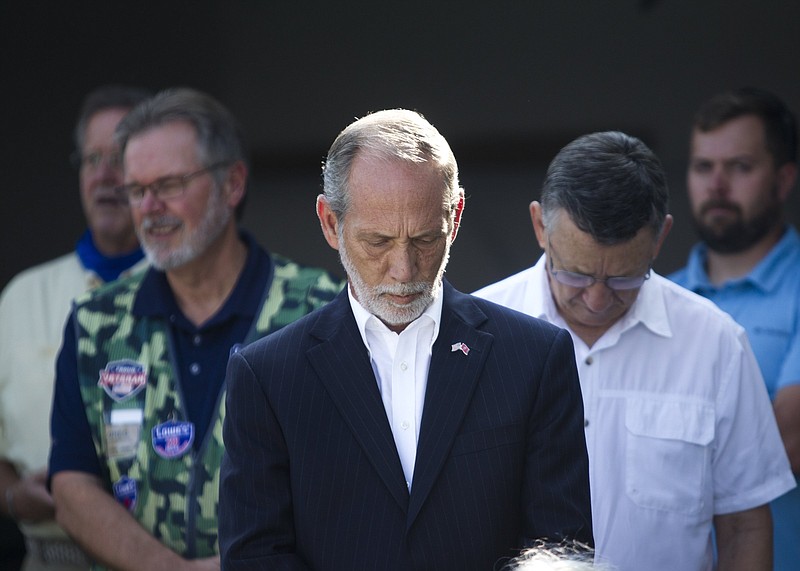 Staff photo by Troy Stolt / Bradley County Mayor Gary Davis stands silently during a ceremony to give the family of the late U.S. Army Veteran J.L. Cross the keys to her new mortgage-free home on Thursday, Sept. 10, 2020, in Cleveland, Tenn.