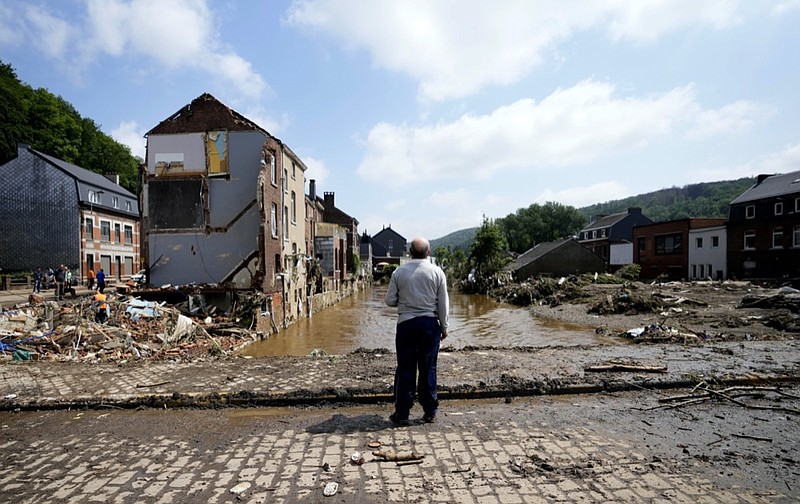 In this Saturday, July 17, 2021 file photo, a man stands on a bridge and surveys the damage after flooding in Pepinster, Belgium. (AP Photo/Virginia Mayo, File)


