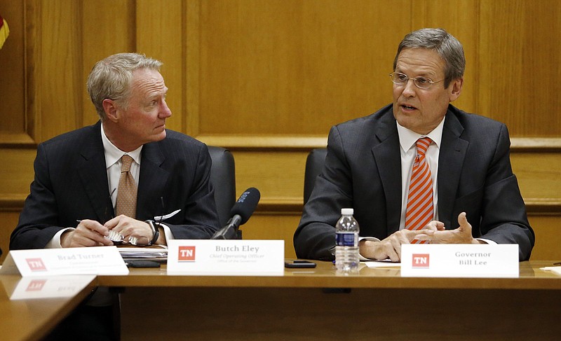 Tennessee Gov. Bill Lee, right, leads his first cabinet meeting, Tuesday, Jan. 22, 2019, in Nashville, Tenn. At left is state Finance Commissioner Butch Eley, . (AP Photo/Mark Humphrey)
