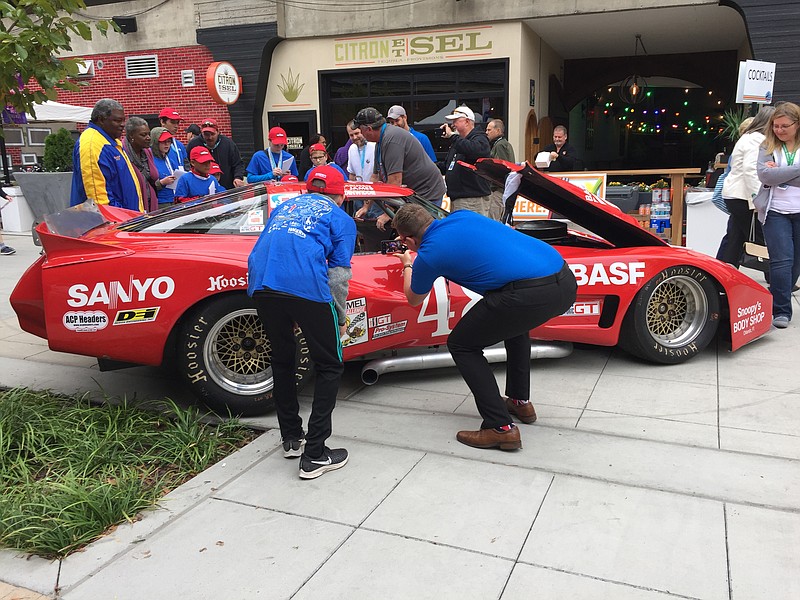 Enthusiasts inspect a race car at the 2019 Chattanooga Motorcar Festival. / Photo by Mark Kennedy