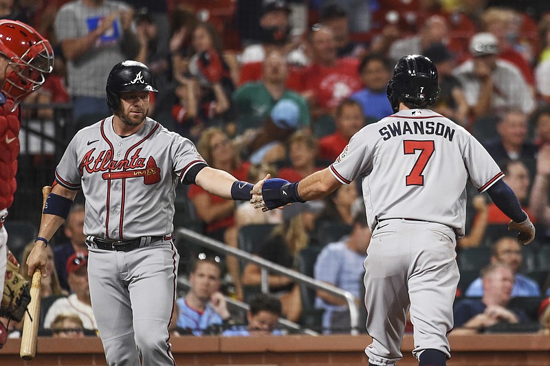 AP photo by Joe Puetz / Atlanta Braves shortstop Dansby Swanson is congratulated by teammate Stephen Vogt after scoring a run during the eighth inning of Thursday night's game against the host St. Louis Cardinals.