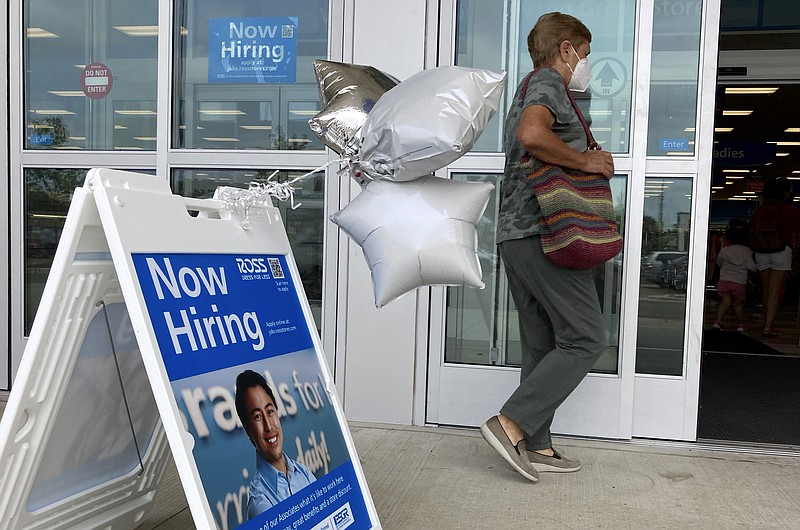 A shopper passes a hiring sign while entering a retail store in Morton Grove, Ill., Wednesday, July 21, 2021. Despite an uptick in COVID-19 cases and a shortage of available workers, the U.S. economy likely enjoyed a burst of job growth last month as it bounces back with surprising vigor from last year's coronavirus shutdown. The Labor Department's July jobs report Friday, Aug. 6 is expected to show that the United States added more than 860,000 jobs in July, topping June's 850,000, according to a survey of economists by the data firm FactSet. (AP Photo/Nam Y. Huh)
