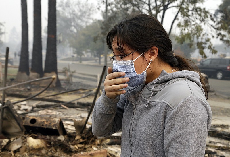 AP file photo / Leslie Garnica cries while recalling the wildfire which destroyed her family home in the Coffey Park area of Santa Rosa, California, in 2015. Coffey Park was one of dozens of communities and towns destroyed by drought-pushed wildfires in recent years.