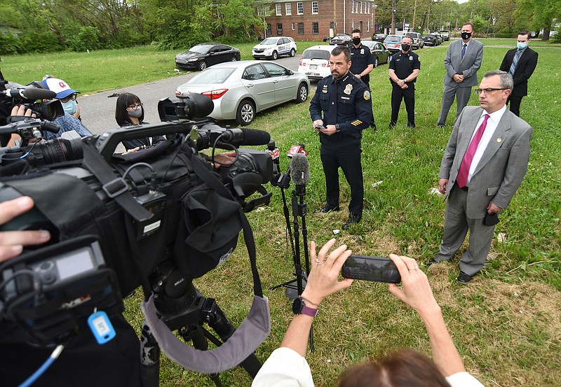 Staff Photo by Matt Hamilton / District Attorney Neal Pinkston, right, speaks with members of the media during a news conference in April.