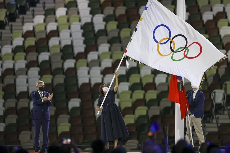 Paris Mayor Anne Hidalgo waves the Olympic flag after receiving it from International Olympic Committee's President Thomas Bach  during the closing ceremony in the Olympic Stadium at the 2020 Summer Olympics, Sunday, Aug. 8, 2021, in Tokyo, Japan. (Dan Mullen/Pool Photo via AP))