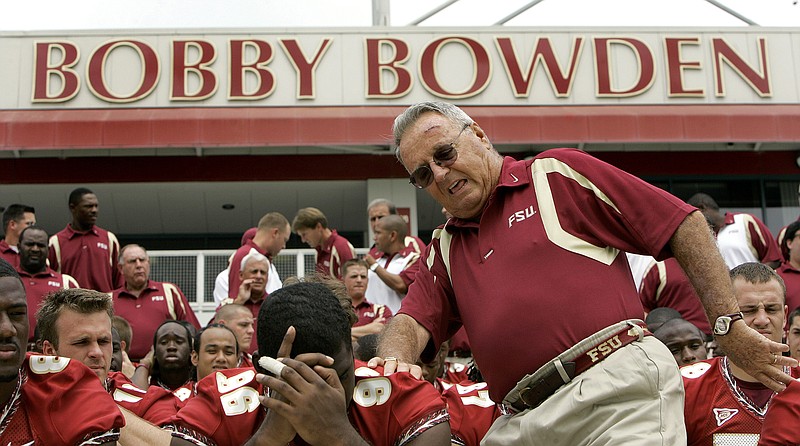 AP photo by Phil Coale / Florida State football coach Bobby Bowden, right, squeezes into his seat for a team photo during media day on Aug. 12, 2007, in Tallahassee. Bowden, who built a dynasty as head coach of the Seminoles from 1976 to 2009, died Sunday at age 91.