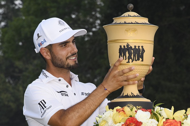 AP photo by John Amis / PGA Tour golfer Abraham Ancer lifts his trophy after winning the FedEx St. Jude Invitational on Sunday at TPC Southwind in Memphis. Ancer won the World Golf Championships event for his first PGA Tour career victory.