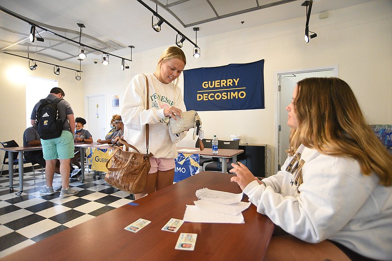 Staff Photo by Matt Hamilton / Decosimo Apartments resident assistant Madison Matthews, right, helps Lebanon, Tenn., resident Eliza Puckett move into her dorm at the University of Tennessee at Chattanooga on Monday, Aug. 9, 2021.