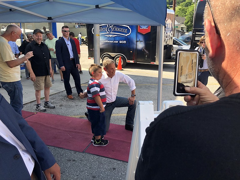 Staff photo by Andy Sher / Tennessee Gov. Bill Lee poses with a young admirer during a July 9, 2021, stop in Gainesboro, Tenn., celebrating the 225th anniversary of Tennessee's admission as the 16th U.S. state.