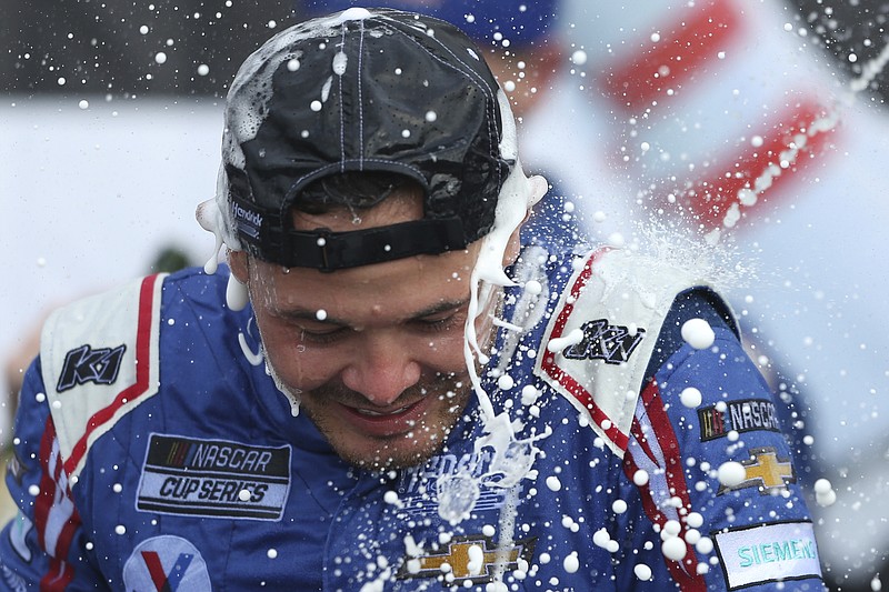 Kyle Larson celebrates winning a NASCAR Cup Series auto race in Watkins Glen, N.Y., on Sunday, Aug. 8, 2021. (AP Photo/Joshua Bessex)