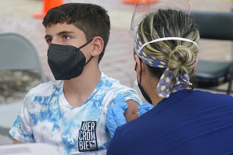 Andres Veloso, 12, gets the first dose of the Pzifer COVID-19 vaccine, Monday, Aug. 9, 2021, in Miami. Florida is reporting a surge of COVID-19 cases caused by the highly contagious delta variant. (AP Photo/Marta Lavandier)