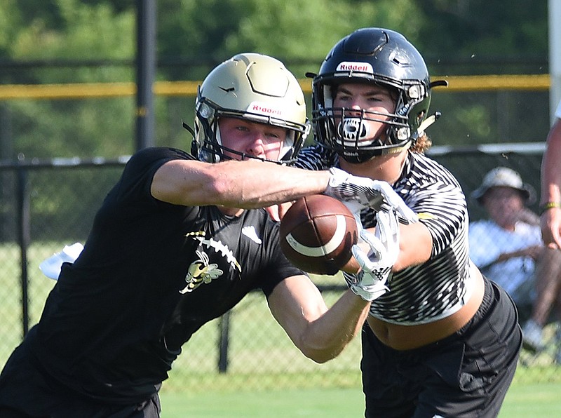 Staff photo by Matt Hamilton / Calhoun's Cole Speer catches a pass as North Murray's Taylor Frazier defends during a July 15 scrimmage in Calhoun.