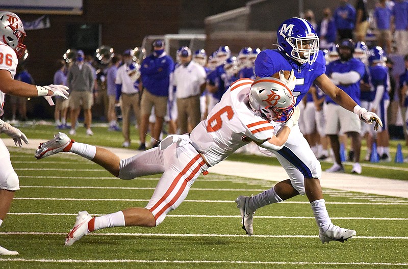 Staff photo by Matt Hamilton / Baylor linebacker Trey McDonald holds on to McCallie running back B.J. Harris during their annual football rivalry matchup last October. While the Blue Tornado must replace Harris, an all-state selection as a senior last year, in their push for a third straight TSSAA Division II-AAA state title, McDonald returns for the Red Raiders as they work to get back to the title game for the first time in a decade.