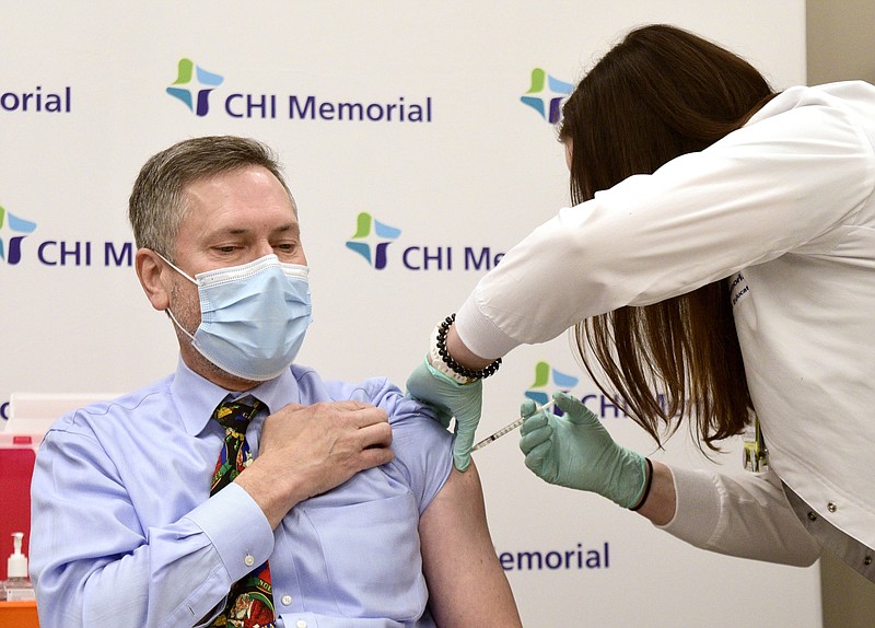 Staff Photo by Robin Rudd / Infectious Disease Specialist Dr. Mark Anderson got his vaccination from Valerie Vargo RN in December.