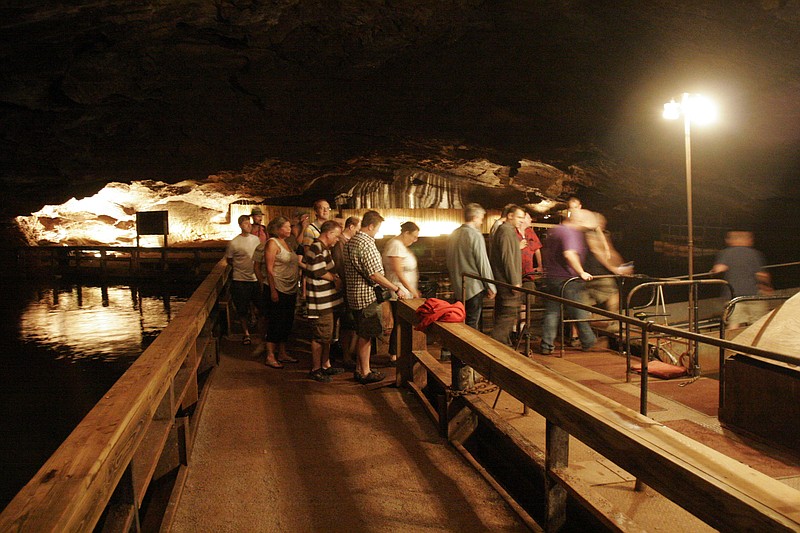 Staff File Photo /Visitors board a boat during a tour of the Lost Sea, America's largest underground lake, in Sweetwater, Tenn.