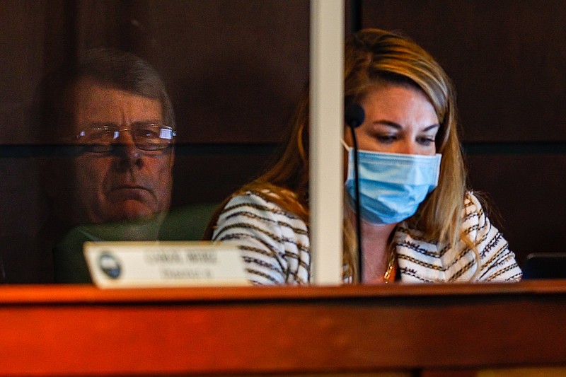 Staff photo by Troy Stolt / Councilman Chip Henderson's face reflects off of a plexiglass barrier as he sits next to City Attorney Emily O?Donnell during the 2021 city budget presentation inside of the City Council Chambers on Tuesday, Aug. 10, 2021 in Chattanooga, Tenn.