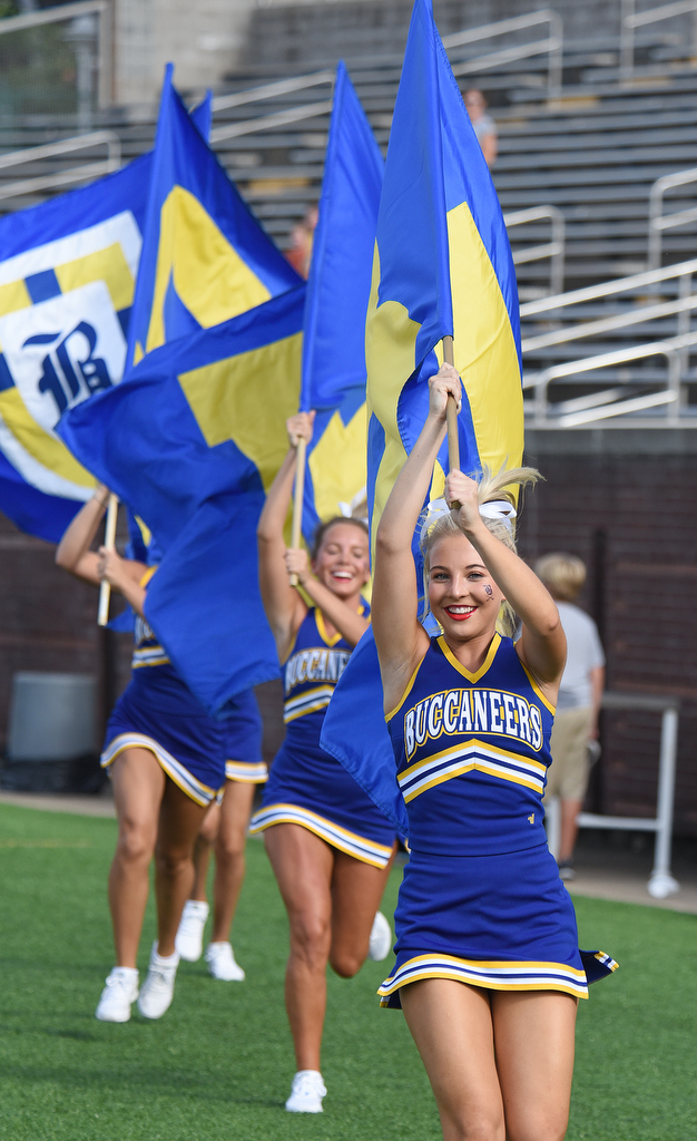 Staff Photo by Matt Hamilton / Boyd Buchanan cheerleader Lauren Richardson, 17, leads a group of cheerleaders carrying flags during the football jamboree Friday. Eight local football teams squared off in eight different 20-minute games Friday, August 13, 2021 at Finley Stadium.