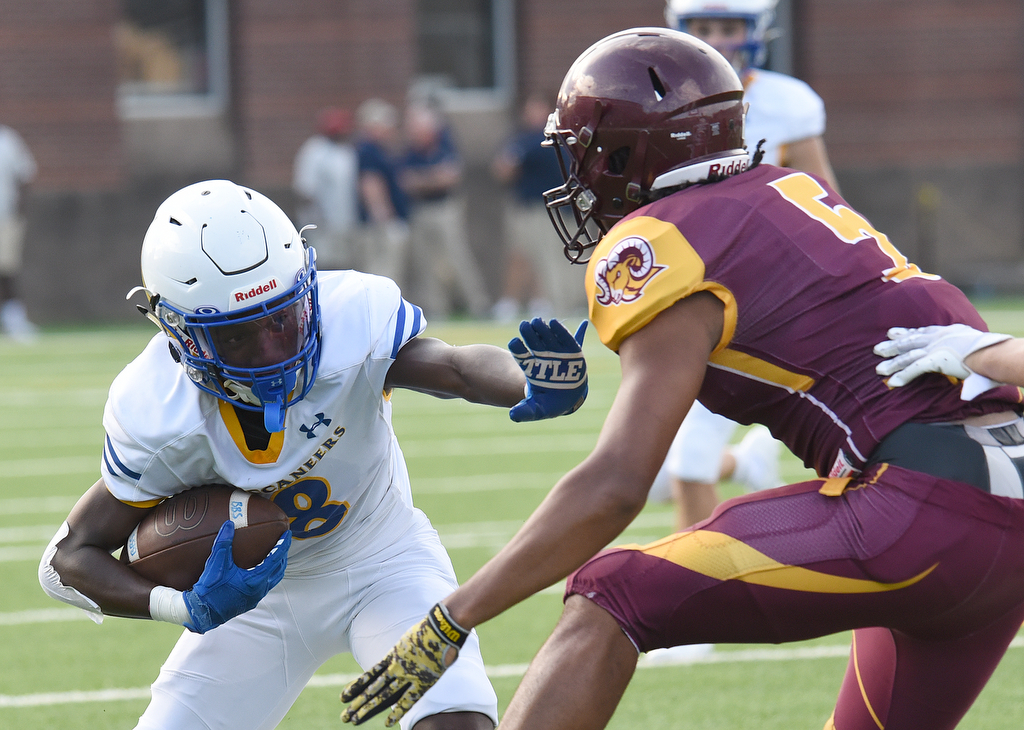 Staff Photo by Matt Hamilton / Boyd Buchanan (8) Darin Shannon runs the ball as Tyner (5) Latavious Conyers defends Friday. Eight local football teams squared off in eight different 20-minute games Friday, August 13, 2021 at Finley Stadium.