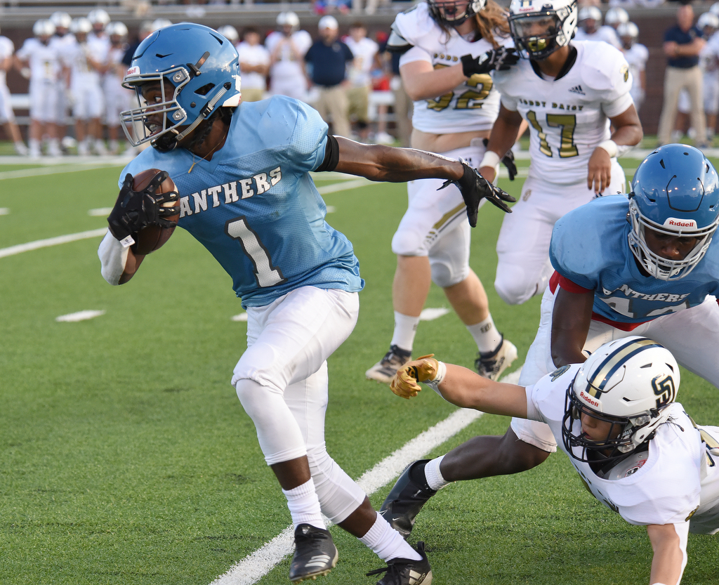 Staff Photo by Matt Hamilton / Brainerd (1) Jaylyn Dupree breaks tackles on a run Friday. Eight local football teams squared off in eight different 20-minute games Friday, August 13, 2021 at Finley Stadium.